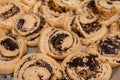 Dough brown pies with poppy seeds lies on baking sheet and ready for baking on row baking paper Royalty Free Stock Photo