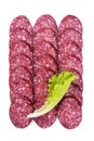 Raw smoked sausage cut into pieces, laid out in rows with lettuce Royalty Free Stock Photo