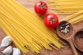 Raw spagetti pasta with tomatoes and garlic Royalty Free Stock Photo