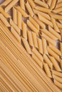 Raw spaghetti on brown parchment, paper background. Close-up pasta, top view. Texture of yellow macaroni. Pattern of italian pasta Royalty Free Stock Photo