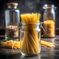 Raw spaghetti in a clear glass jar on a black dining table Royalty Free Stock Photo