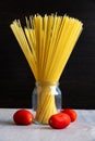 Raw spaghetti pasta and tomatoes Royalty Free Stock Photo