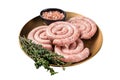 Raw spiral pork sausages, uncooked Wurst. Isolated on white background.