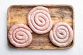 Raw spiral sausage  on white background  top view flat lay Royalty Free Stock Photo