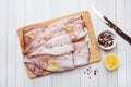 Raw squid carcass with spices and lemon ready for cooking on the table Royalty Free Stock Photo