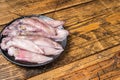 Raw squid, fresh calamari in a plate. Wooden background. Top view. Copy space