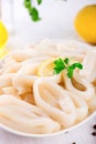 Raw squid rings on white plate, ready to cook Royalty Free Stock Photo