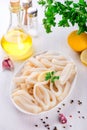 Raw squid rings on white plate, ready to cook Royalty Free Stock Photo