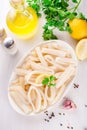 Raw squid rings on white plate, ready to cook Royalty Free Stock Photo