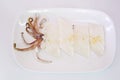 Raw squid slice on white dish isolate on white background ready Royalty Free Stock Photo