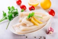 Raw squids and ingredients on the white plate Royalty Free Stock Photo