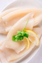 Raw squids and ingredients on the white plate Royalty Free Stock Photo