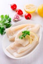 Raw squids and ingredients on the white plate Royalty Free Stock Photo