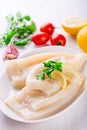 Raw squids and ingredients on the white plate Royalty Free Stock Photo