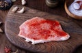 Raw steak sprinkled with red paprika and pepper mix