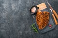 Raw steak t-bone or porterhouse. Steak t-bone or porterhouse in sauce with spices, salt and rosemary on a black ceramic plate on c Royalty Free Stock Photo