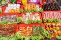 Raw steaks, sausages, meat, and vegetables on skewers in Vietnamese street market