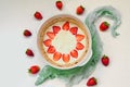 Raw strawberry tart on the white kitchen background. Berries cheesecake decorated with organic fresh strawberries and mint Royalty Free Stock Photo