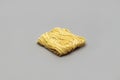 Raw strips of egg noodles on gray background Royalty Free Stock Photo