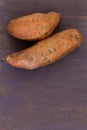 Raw Sweet potato on a purple wood background Royalty Free Stock Photo