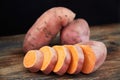 Raw sweet potatoes batatas on a rustic wooden table Royalty Free Stock Photo