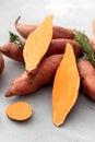 Raw sweet potatoes whole and cut. Orange kumara, sweet potato. Harvesting of root crops. Royalty Free Stock Photo