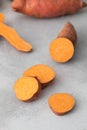 Raw sweet potatoes whole and cut. Orange kumara, sweet potato. Harvesting of root crops. Royalty Free Stock Photo