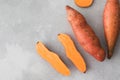 Raw sweet potatoes whole and cut. Orange kumara, sweet potato. Harvesting of root crops. Copy space Royalty Free Stock Photo
