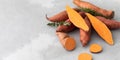 Raw sweet potatoes whole and cut. Orange kumara, sweet potato. Harvesting of root crops. Copy space Royalty Free Stock Photo