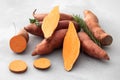 Raw sweet potatoes whole and cut. Orange kumara, sweet potato. Harvesting of root crops. Royalty Free Stock Photo