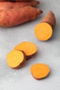 Raw sweet potatoes whole and cut. Orange kumara, sweet potato. Harvesting of root crops. Royalty Free Stock Photo