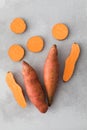 Raw sweet potatoes whole and cut. Orange kumara, sweet potato. Harvesting of root crops. Royalty Free Stock Photo