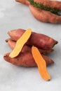 Raw sweet potatoes whole and cut. Orange kumara, sweet potato. Harvesting of root crops. Royalty Free Stock Photo