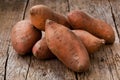 Raw sweet potatoes on wooden background closeup Royalty Free Stock Photo