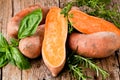 Raw sweet potatoes on wooden background closeup Royalty Free Stock Photo