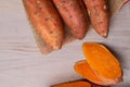 Raw sweet potatoes on wooden background copy space Royalty Free Stock Photo