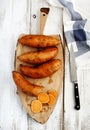 Raw sweet potatoes on wooden cooking board Royalty Free Stock Photo