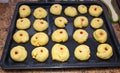 Raw sweet yeast dough on a baking sheet, filling buns jam. Royalty Free Stock Photo