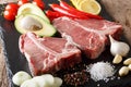 Raw t-bone steak with ingredients close-up. horizontal Royalty Free Stock Photo