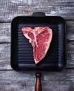 Raw T-bone steak on iron grill pan Royalty Free Stock Photo