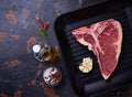 Raw T-bone steak on iron grill pan Royalty Free Stock Photo