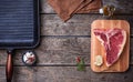 Raw T-bone steak and iron grill pan Royalty Free Stock Photo