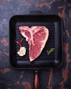 Raw T-bone steak on iron grill pan Royalty Free Stock Photo