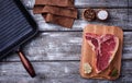 Raw T-bone steak and iron grill pan Royalty Free Stock Photo