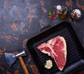 Raw T-bone steak on iron grill pan Royalty Free Stock Photo