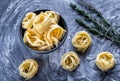 Raw tagliatelle nido on the flour-dusted black wooden background Royalty Free Stock Photo