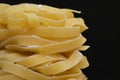 Raw Tagliatelle Pasta on Black Background Royalty Free Stock Photo