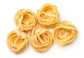 Raw Tagliatelle Pasta Nests Isolated On White Background