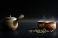 Teapots and two tea cups have smoke from the heat on a black background Royalty Free Stock Photo