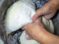 Raw thick dough in the hands of a woman baker. Ready dough for baking in a pan. Royalty Free Stock Photo